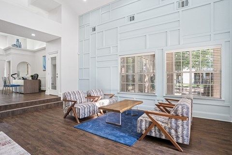 Clubhouse area in leasing office with seating and a coffee table at La Costa Apartments in Plano, TX