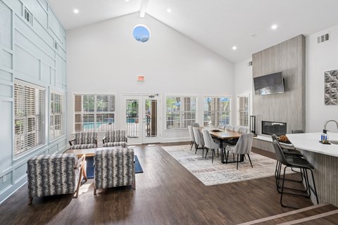 Modern clubhouse with comfortable seating and a TV at La Costa Apartments in Plano, TX