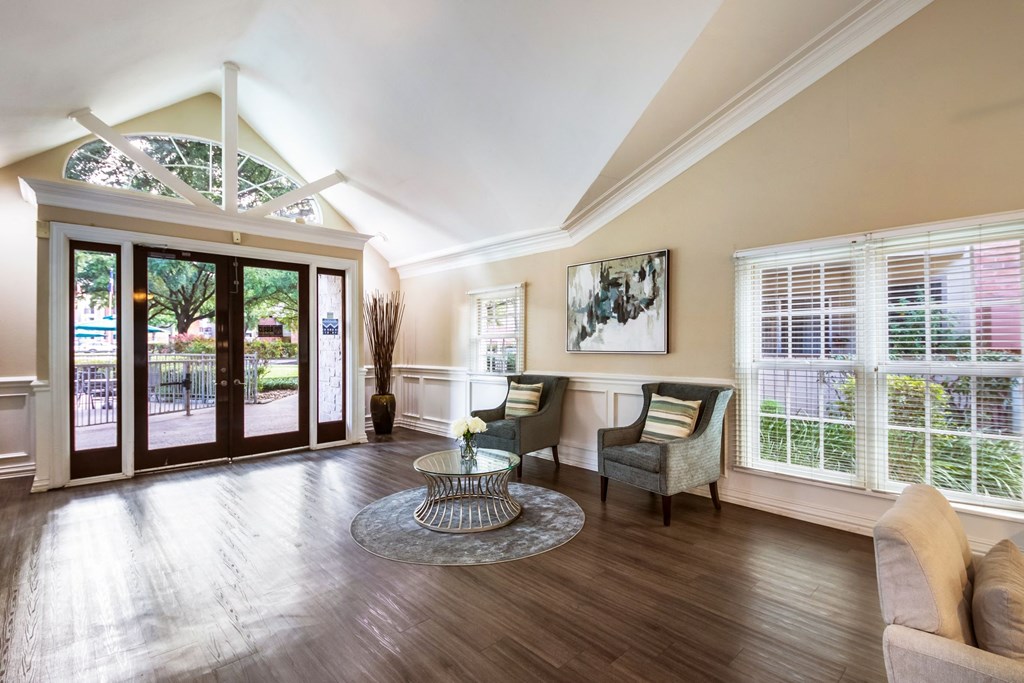the living room of a house with a large glass door and windows