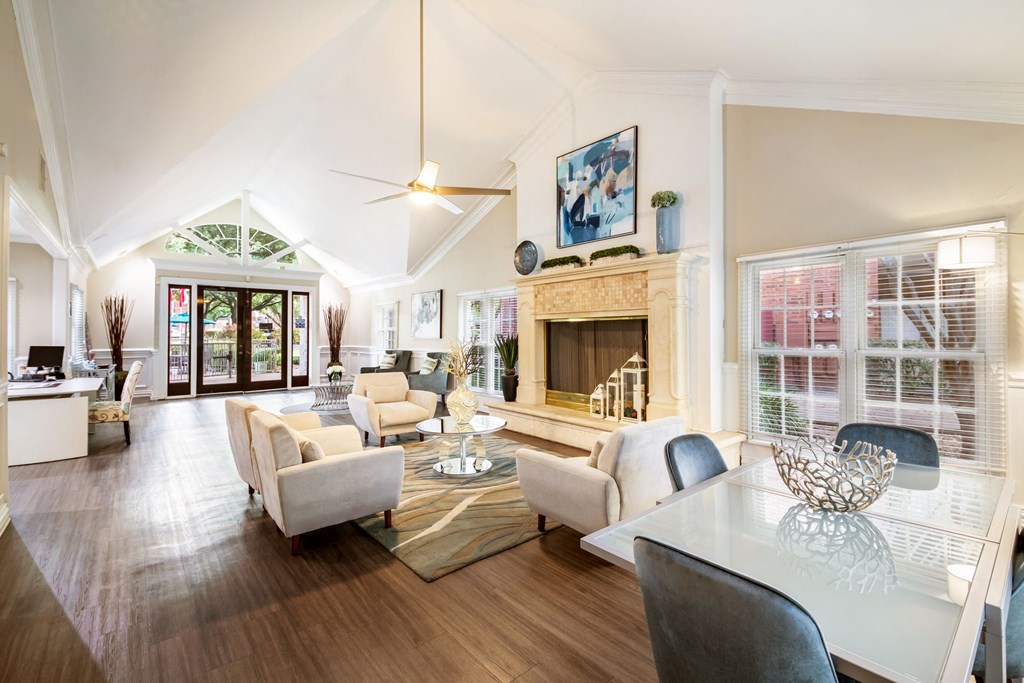 a living room with a fireplace and a table and chairs
