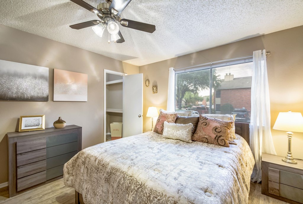 a bedroom with a bed and a ceiling fan