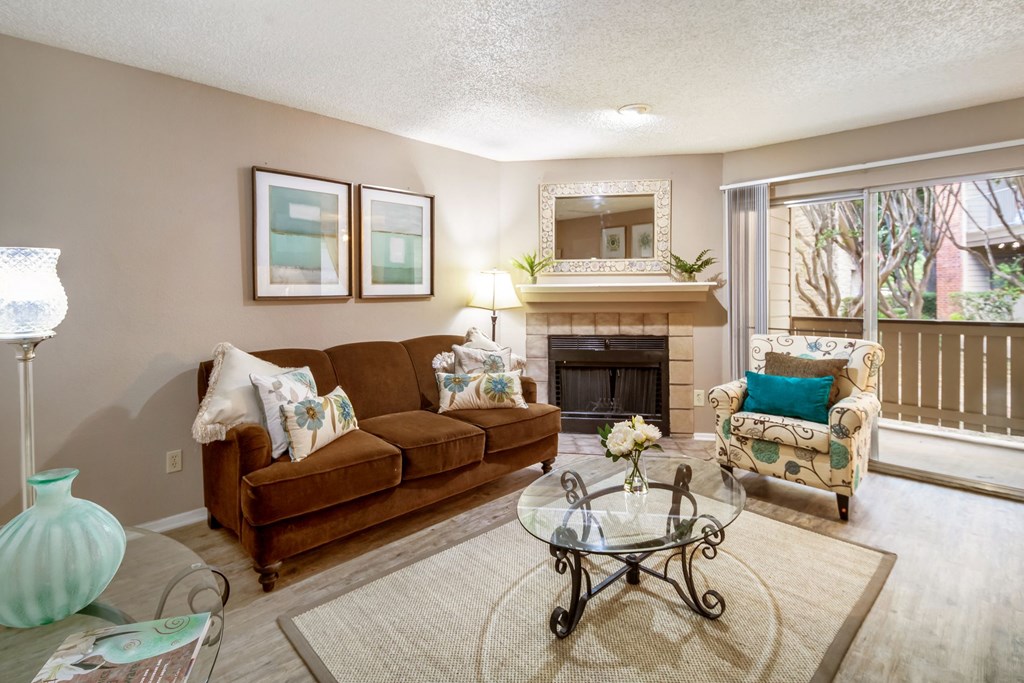 a living room with a couch and a chair and a fireplace