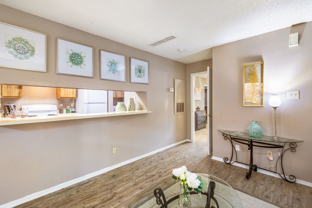 a living room with a dining room table and a kitchen