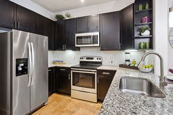 a kitchen at Muse at Museum District, Houston, TX