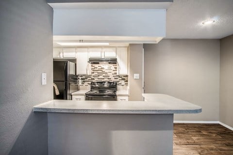 Unit Kitchen with Bar Counter at The Players Club Apartments in Nashville, TN
