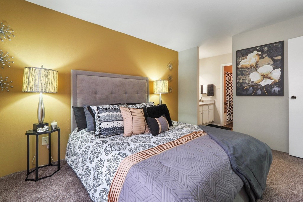 a bedroom with a bed and two lamps