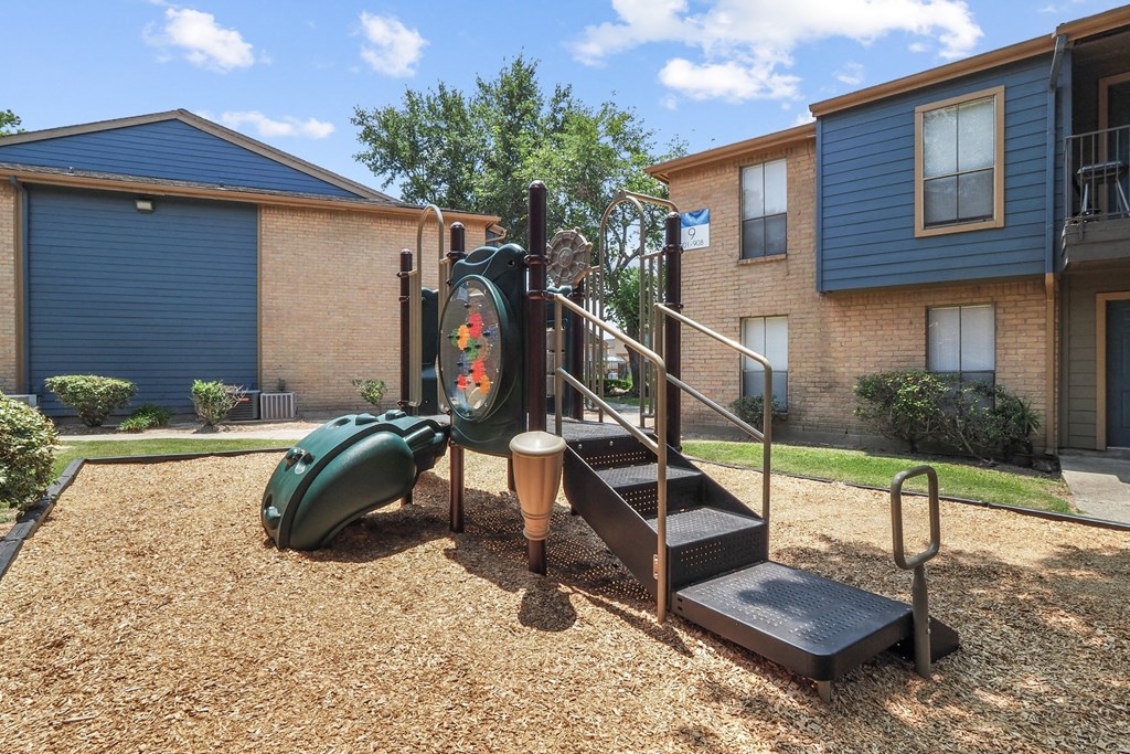 a playground at the whispering winds apartments in pearland, tx