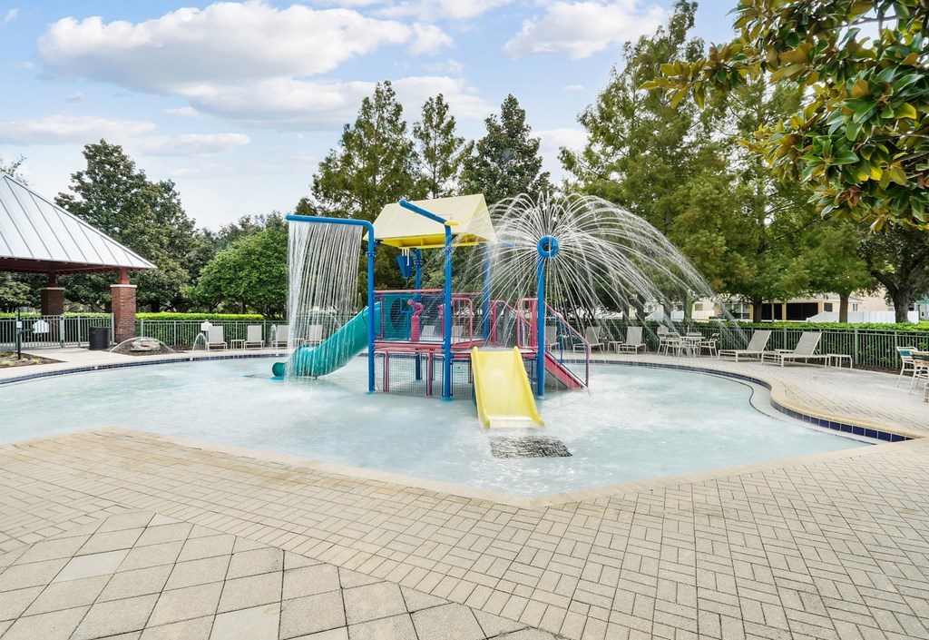 A water park with a slide and a waterfall at Wynnfield Lakes Apartments in Jacksonville, FL