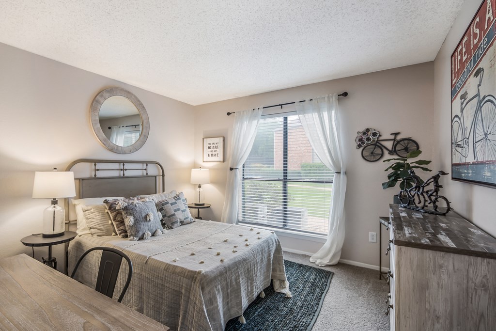 a bedroom with a bed and a window