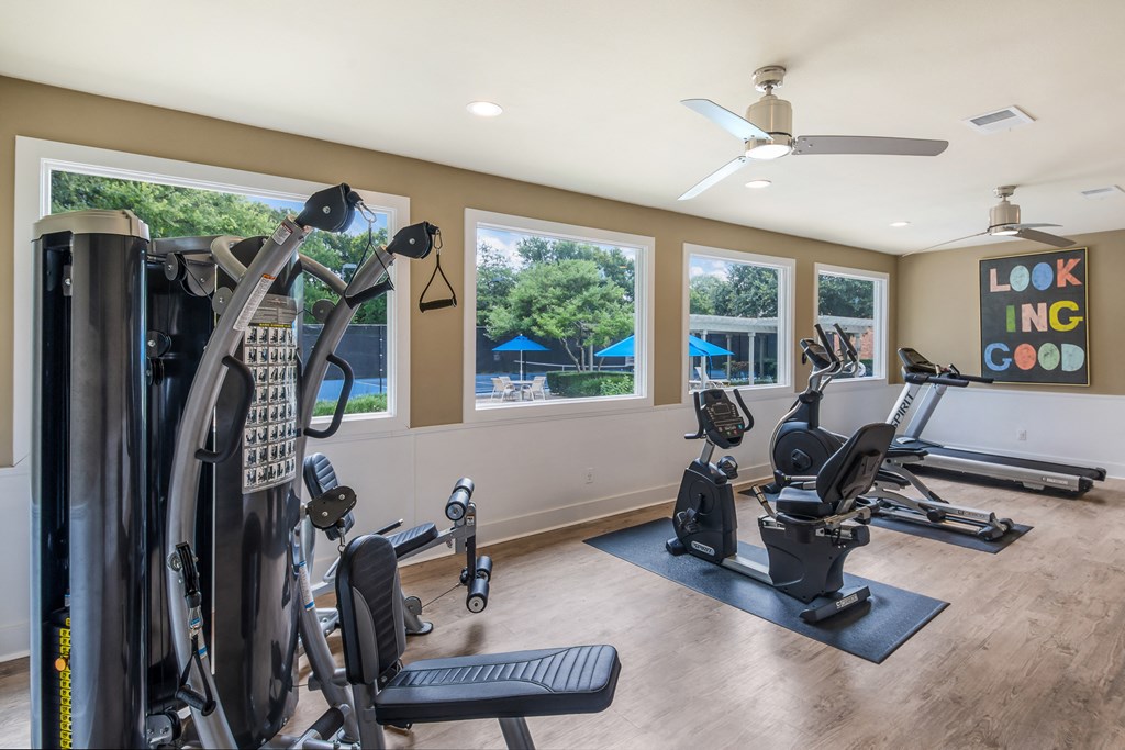 a home gym with exercise equipment and windows