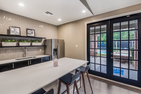 a kitchen with a long counter and a door to a patio