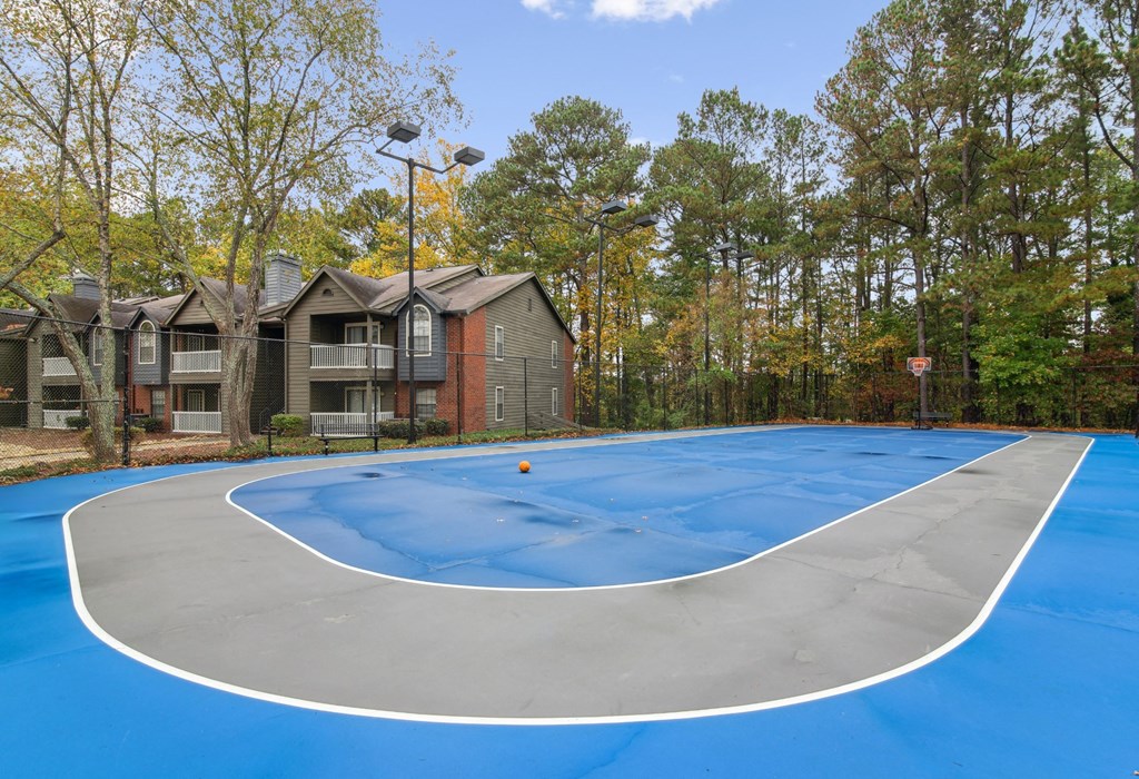 a basketball court with apartments in the background at Woodmere Trace at Duluth, GA