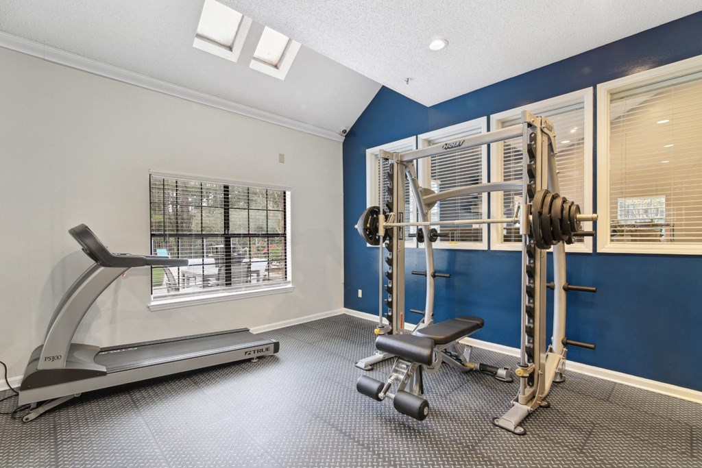 Gym with weights and cardio machines at Woodmere Trace at Duluth, GA