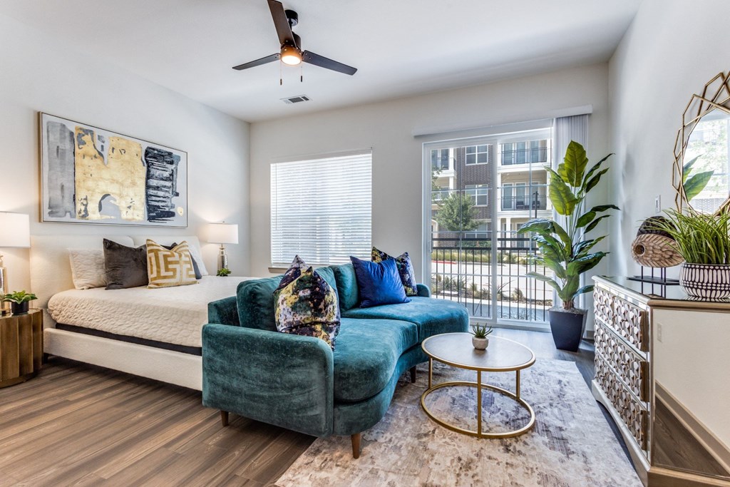 Model Studio apartment living room with a bed and a couch at Era Apartments in Denton, TX