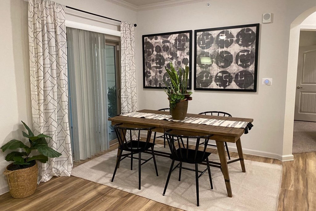 a dining room with a table and chairs and pictures on the wall of Avery Oaks in Austin, TX