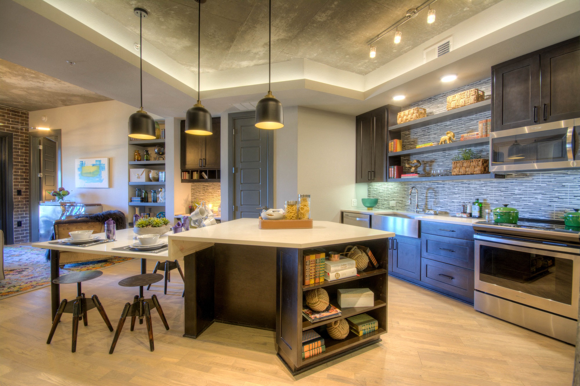 Open floor plan layout of kitchen in apartment with island at The Case Building in Dallas, TX