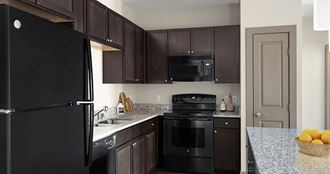 a kitchen with black appliances and granite counter tops