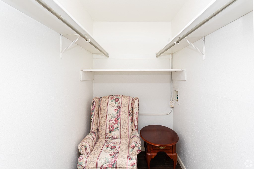 a small room with a chair and a table