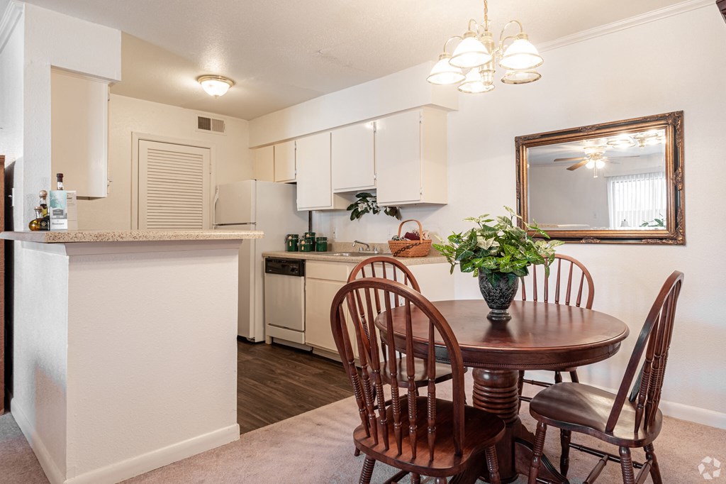 a dining room and kitchen with a table and chairs