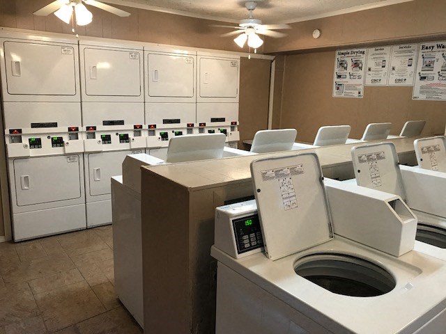 a laundry room with washing machines and a washer and dryer