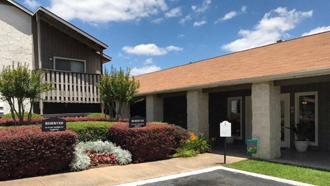 a building with a brown roof and a sign in front of it