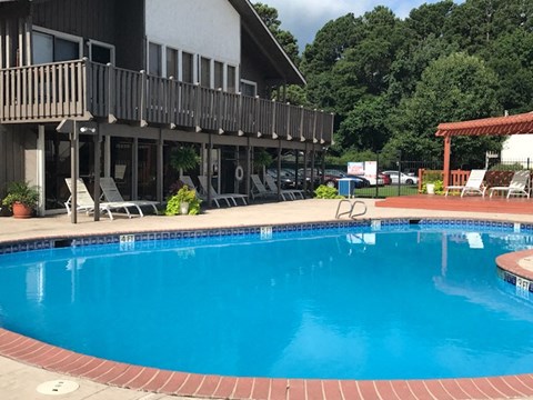 a large swimming pool in front of a building