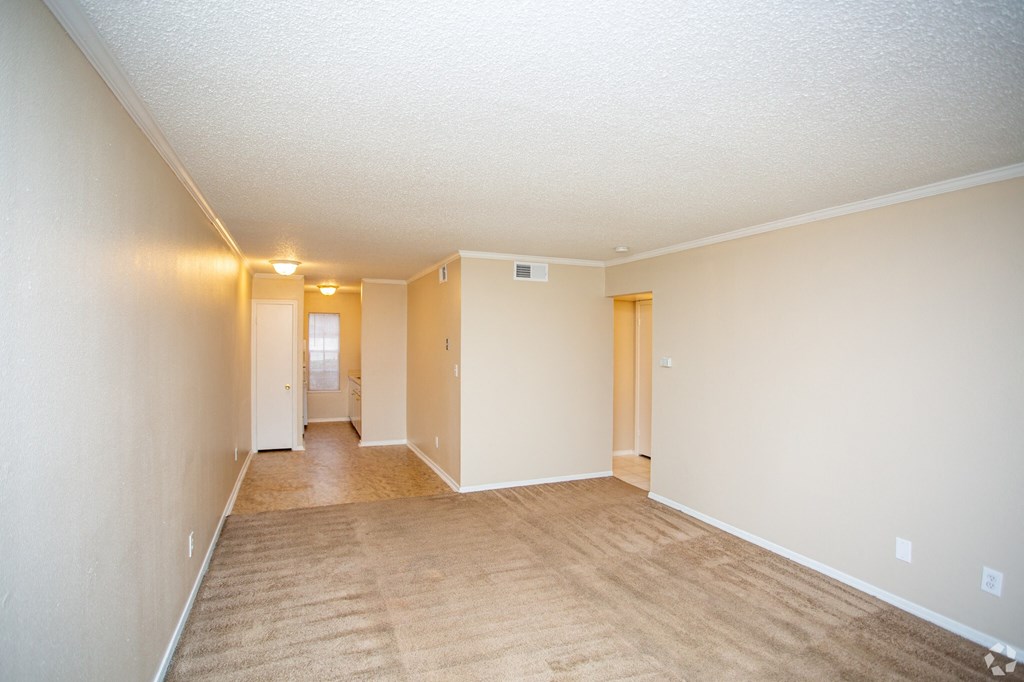 the living room and dining room of an empty house