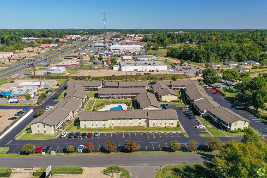an aerial view of a parking lot and buildings in a city