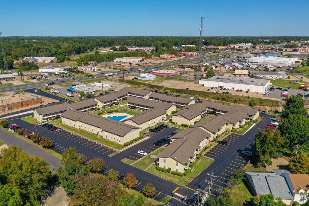 an aerial view of a city with buildings and a parking lot