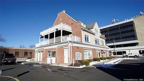 A building with a red brick facade and a white balcony.
