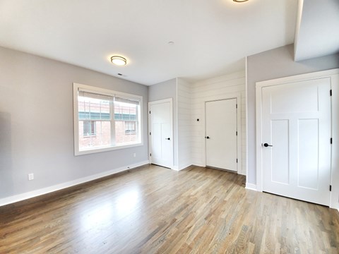 A room with wooden floors and white walls.