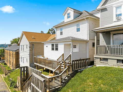 A row of houses with a wooden deck in front.