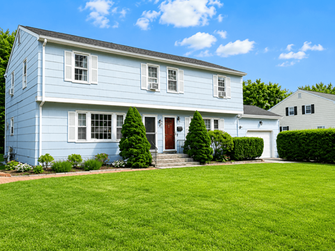 A blue house with a red door and white trim.