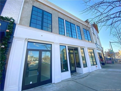 A white building with black doors and windows.