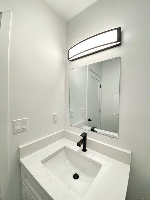 A bathroom with a sink and mirror.