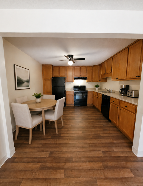A kitchen with wooden floors and furniture.