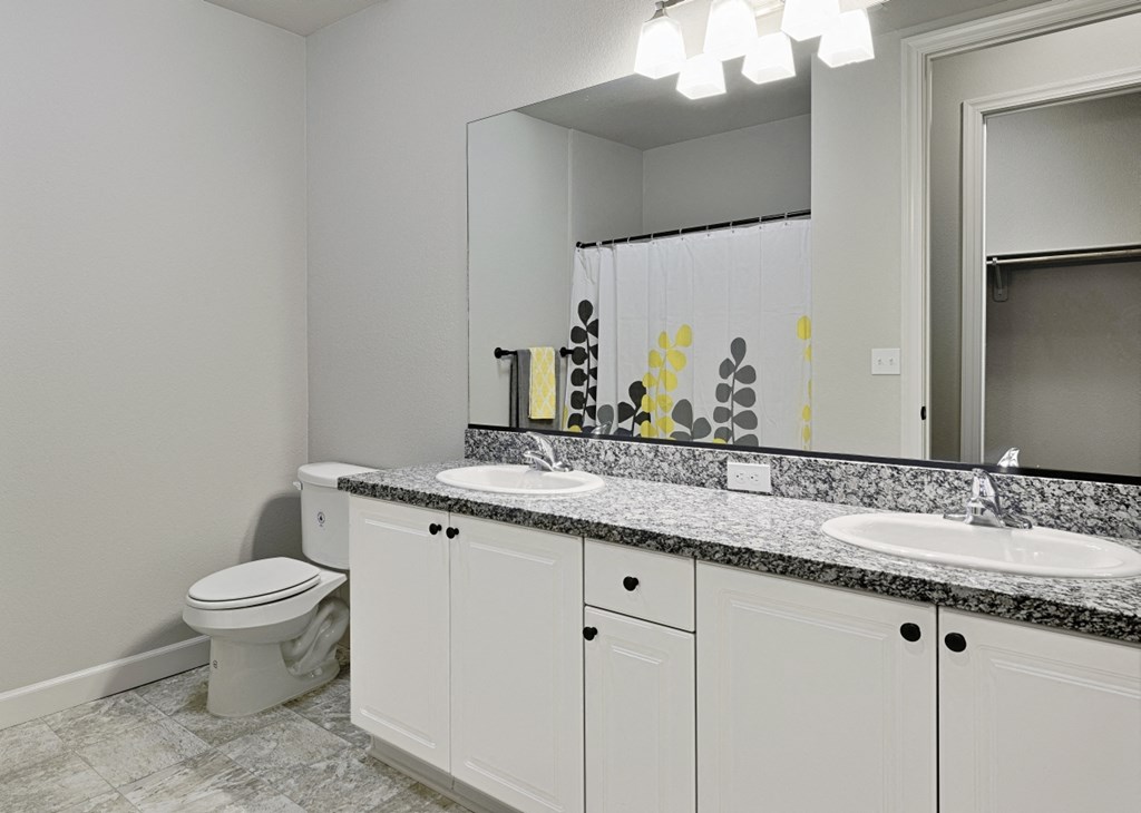 a white bathroom with two sinks and a toilet
