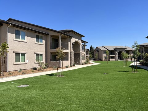 a green lawn in front of a building