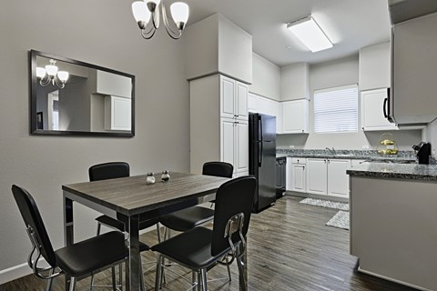 a kitchen and dining room with a table and chairs