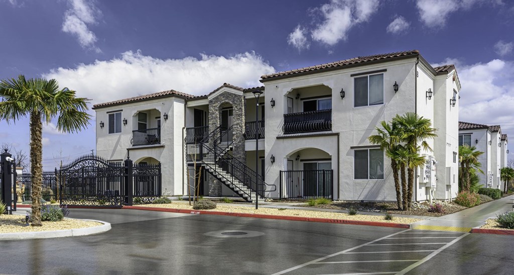 a street view of a building with palm trees