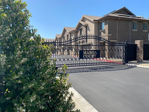 a house with a gate with a sign that reads court