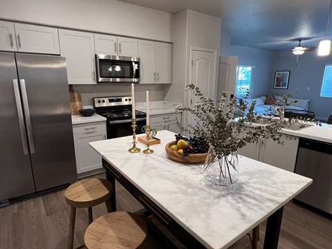 a kitchen with stainless steel appliances and a marble counter top
