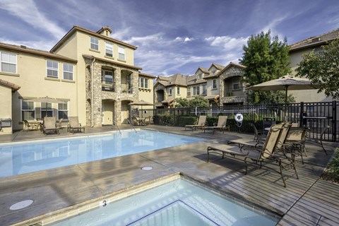 our apartments have a large swimming pool with chairs and umbrellas