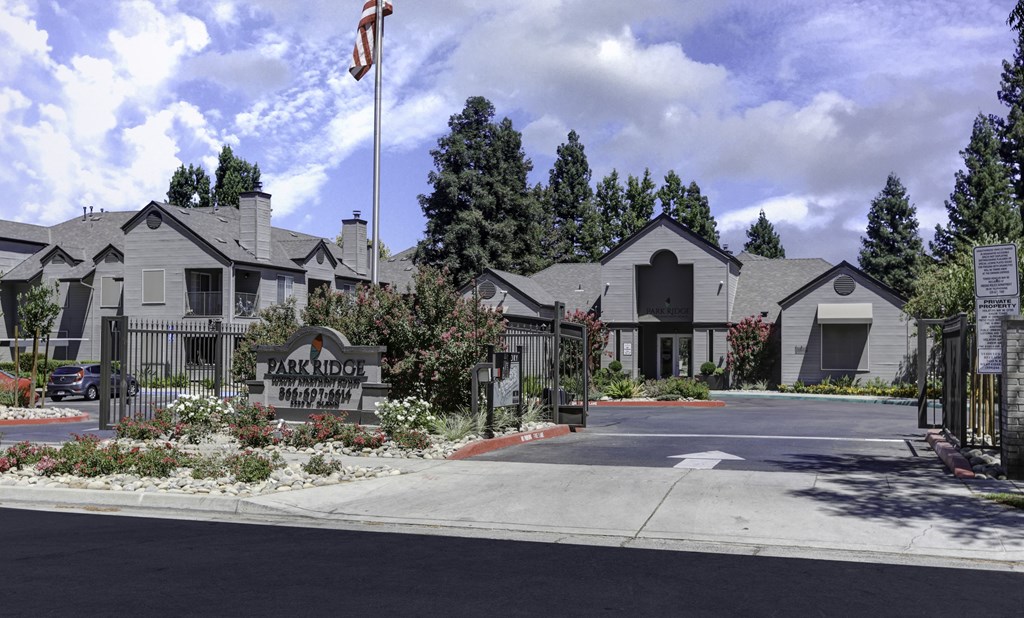 The image shows a building with the sign "Park Ridge" and a flagpole with an American flag in front of it.