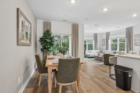 A dining room with a table and chairs.