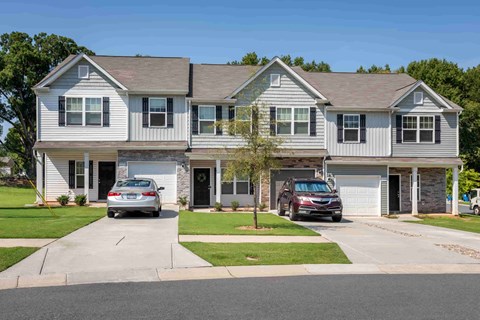 A two-story house with a grey and white exterior and a garage.