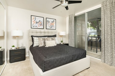 a bedroom with a bed and a ceiling fan