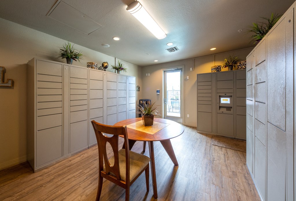 a dining room with a table and two wooden chairs