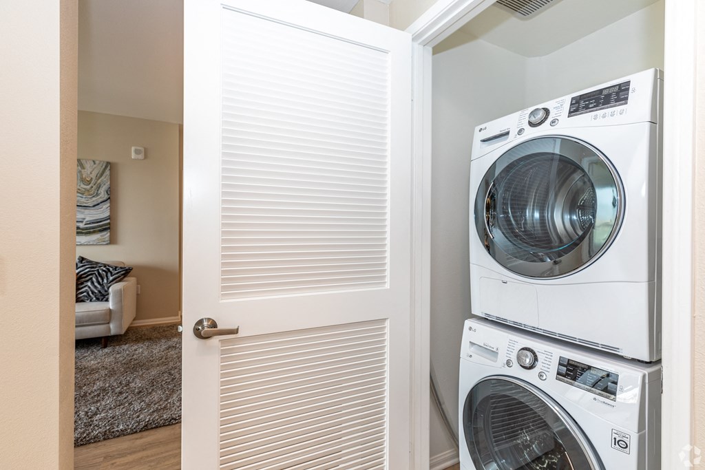 a door to a laundry room with a washer and dryer
