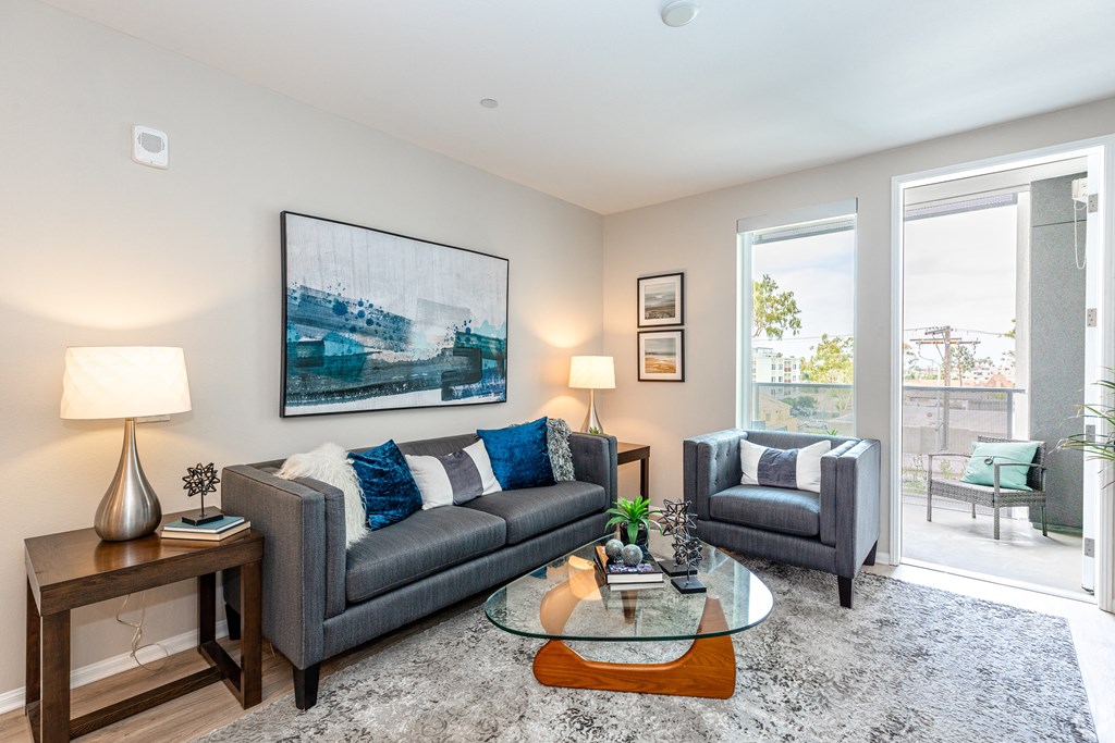 a living room with two couches and a glass coffee table